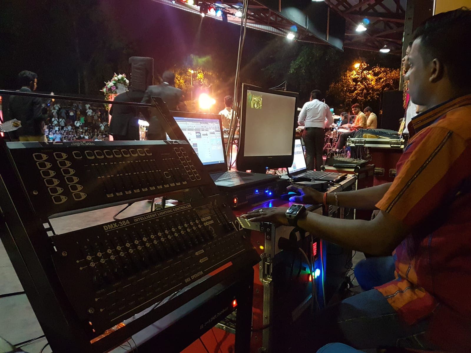 Sound console and playback laptop at an outdoor night event