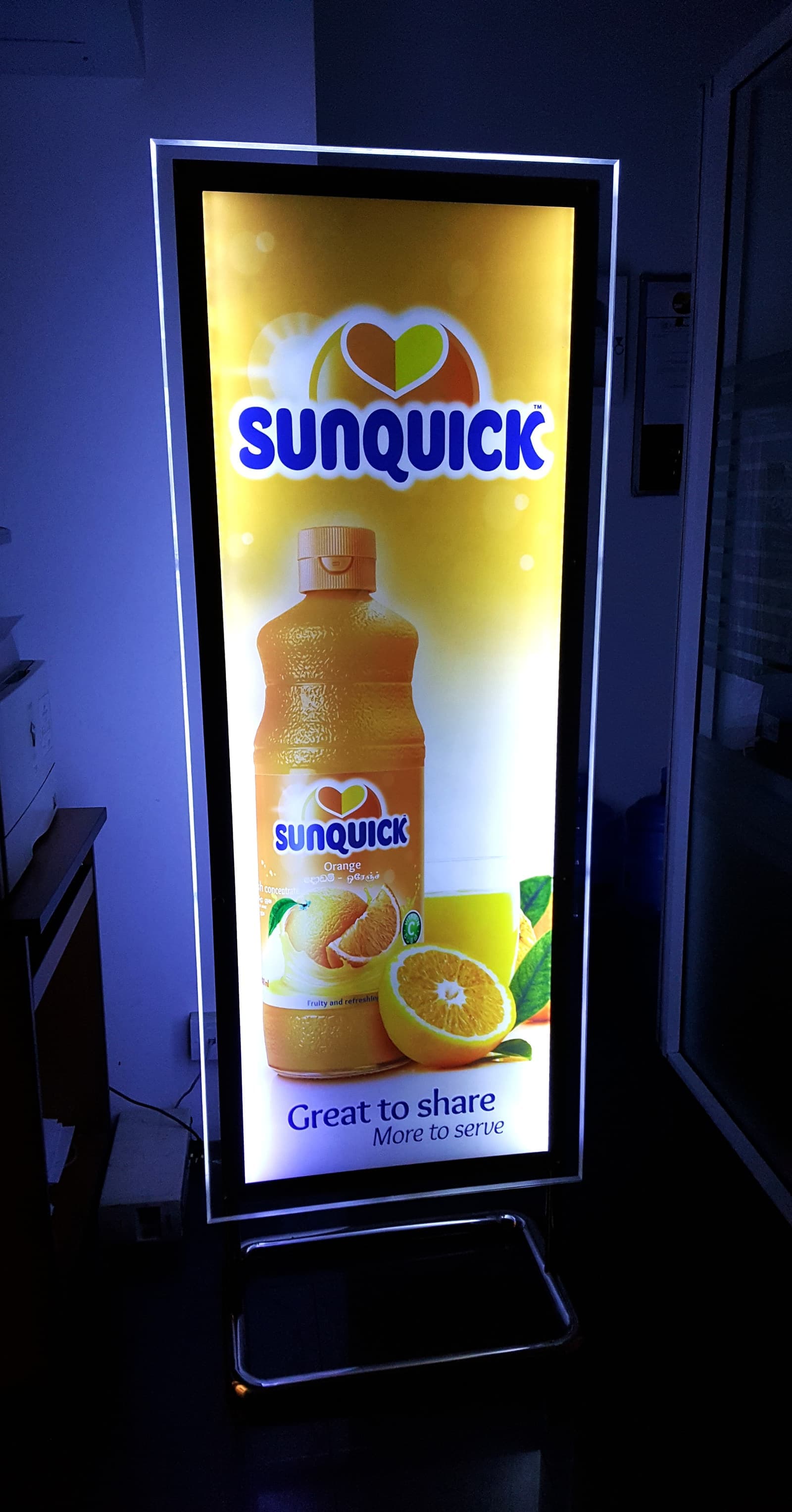 Sunquick backlit lightbox with an orange-juice bottle
