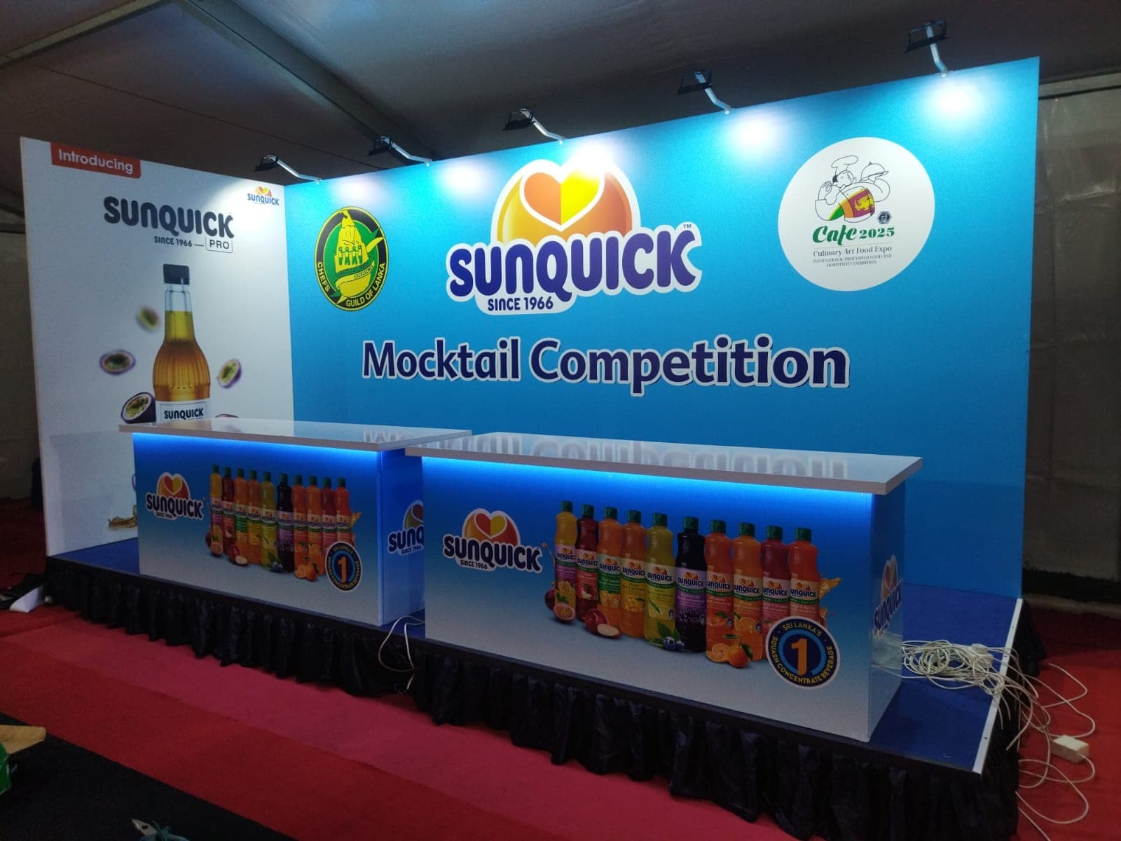 Sunquick Mocktail Competition stall, backlit bar lined with product bottles