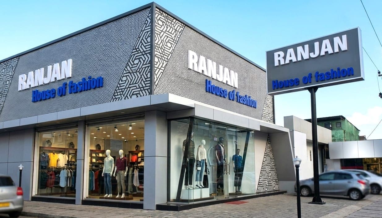 Ranjan House of Fashion shopfront fascia signage with a matching pole-mounted dealer board