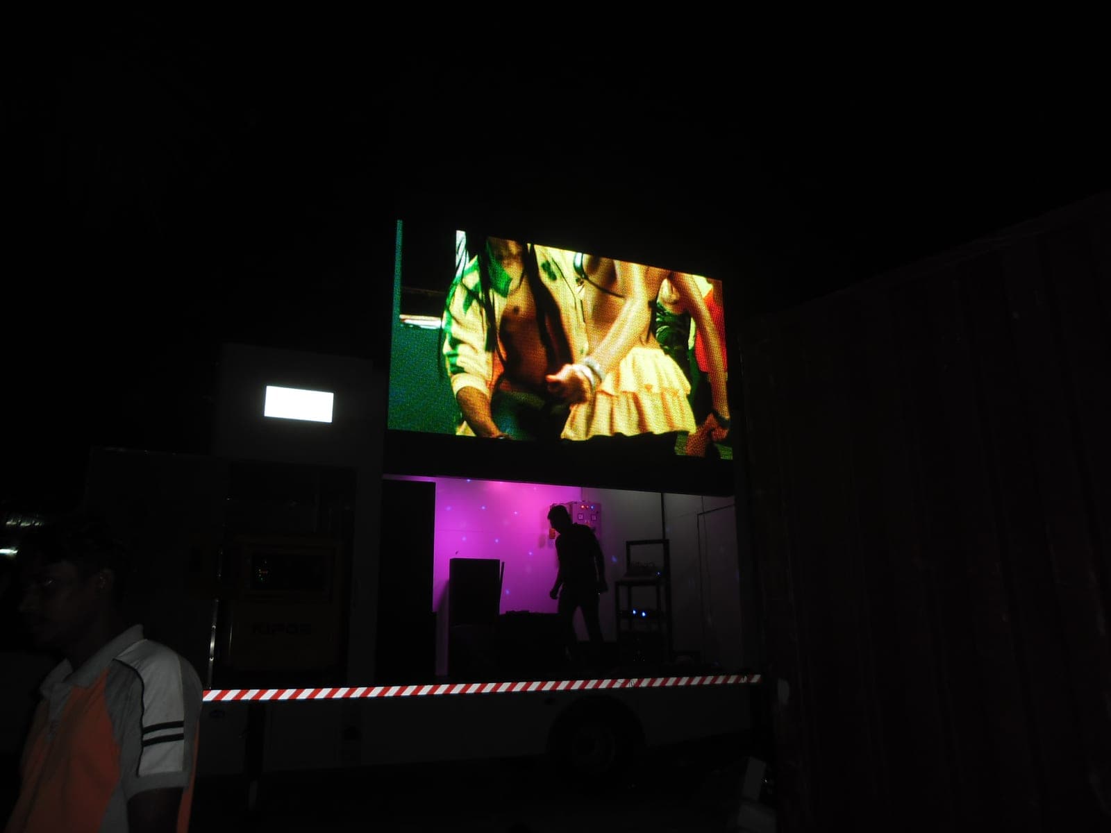 Mobile LED truck screen playing video at night